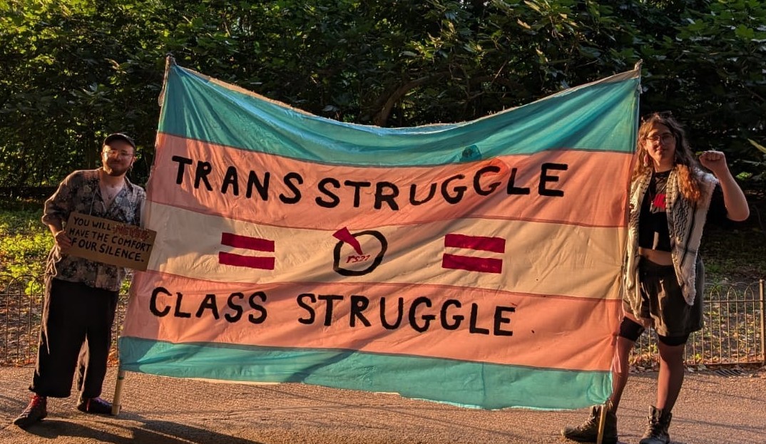 People hold banner reading Trans Struggle = Class Struggle rs21